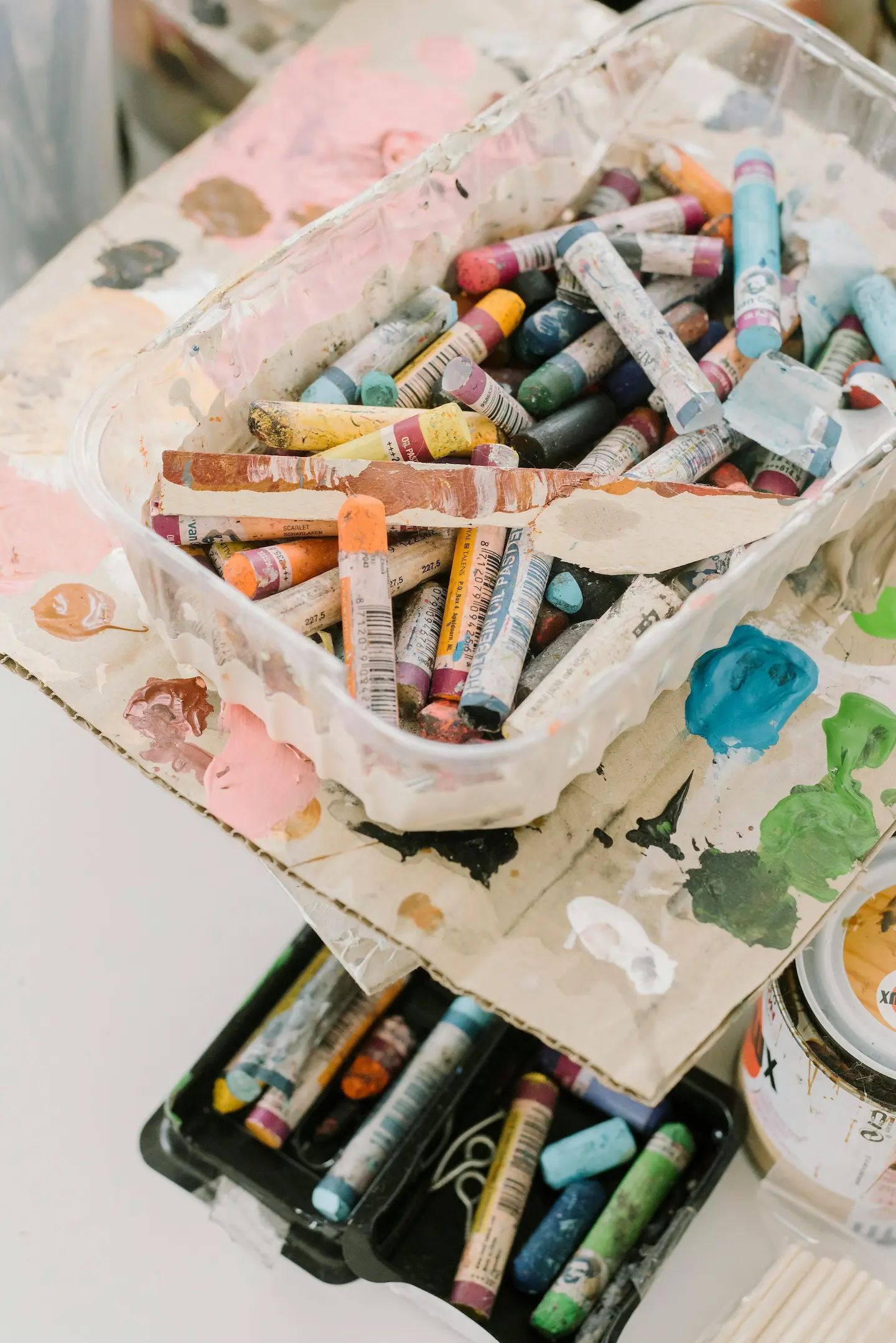 Tray of oil pastels and art supplies to assist with trauma and anxiety release in therapy sessions.